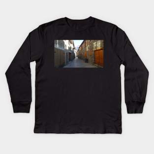 Cobblestones streets in Queralbs, Catalonia, Spain, Narrow, narrow old architecture Kids Long Sleeve T-Shirt